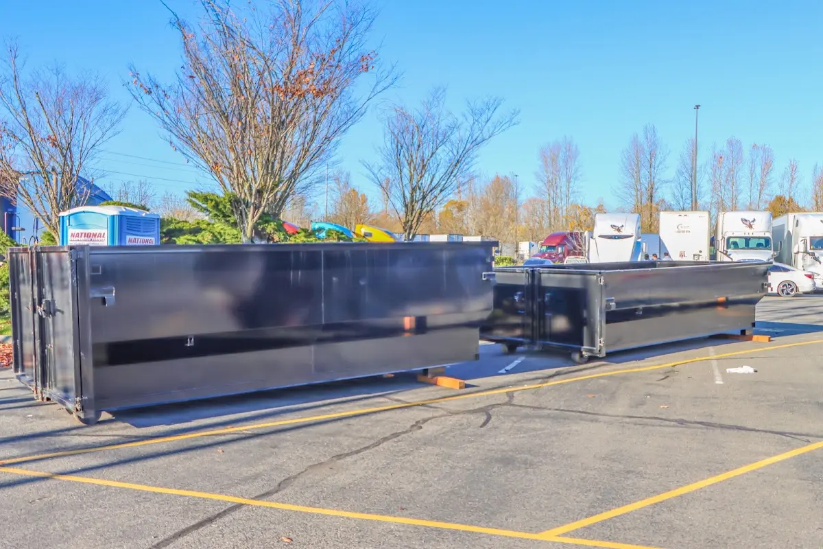 Professional dumpster rental service with roll-off container on residential driveway in Charlottesville